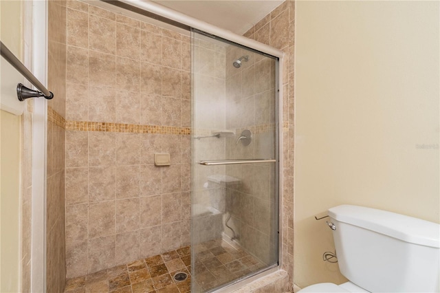 bathroom featuring walk in shower and toilet