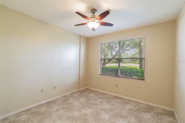 tiled spare room with a textured ceiling and ceiling fan