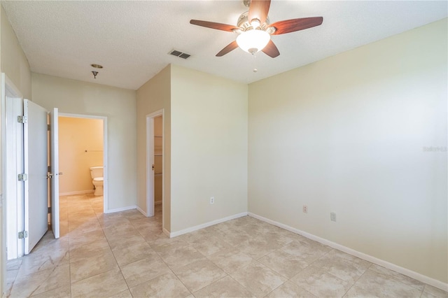 unfurnished room featuring ceiling fan and a textured ceiling