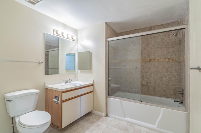 full bathroom featuring toilet, vanity, tile patterned flooring, and shower / bath combination with glass door