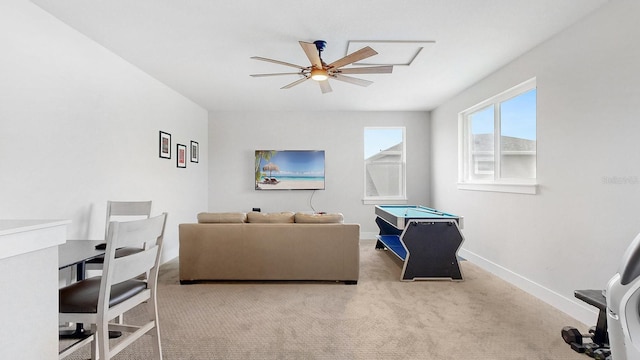 carpeted living room with ceiling fan