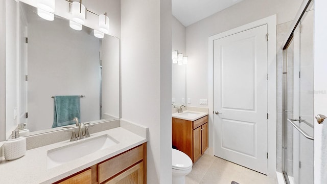 bathroom with walk in shower, tile patterned floors, vanity, and toilet