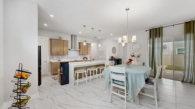 dining area with sink and a chandelier