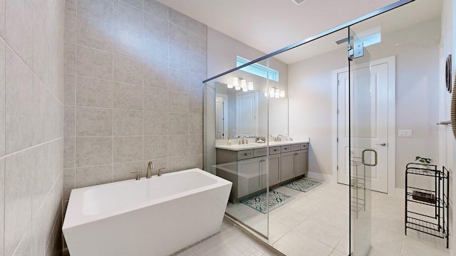 bathroom with plus walk in shower, tile walls, tile patterned floors, and vanity