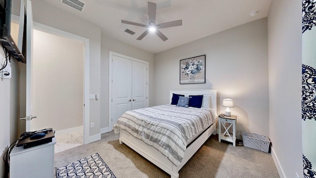 bedroom featuring light colored carpet, a closet, and ceiling fan