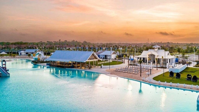 view of pool at dusk