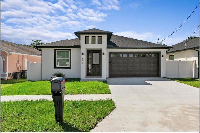 view of front of house featuring a garage and a front lawn