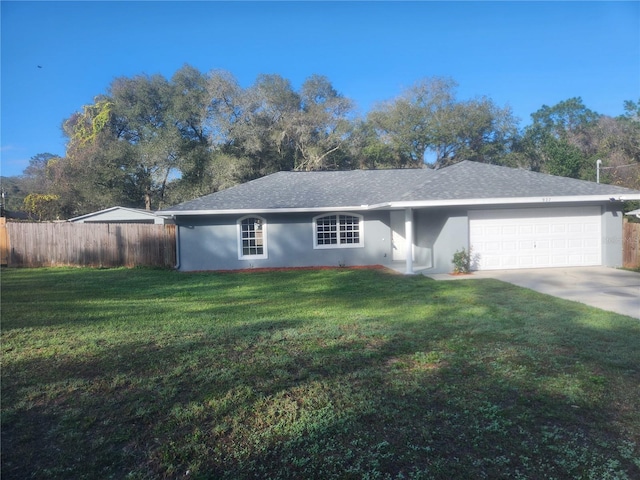 ranch-style house featuring a garage and a front yard