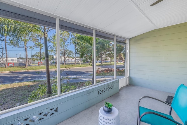 sunroom / solarium featuring vaulted ceiling