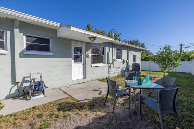 exterior space featuring a patio, cooling unit, and a lawn