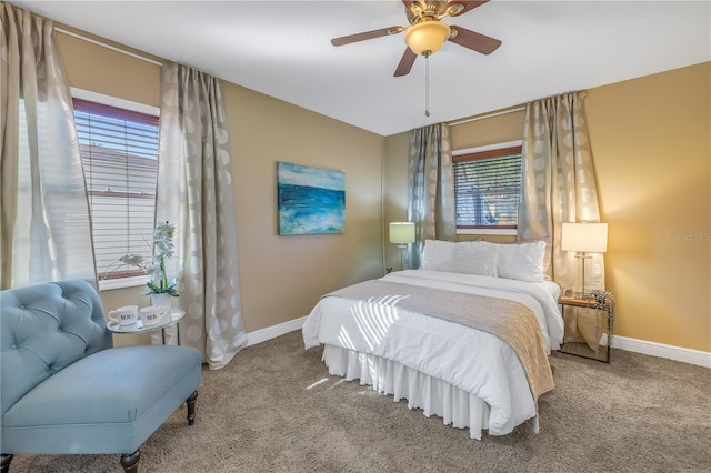 bedroom featuring multiple windows, ceiling fan, and carpet floors