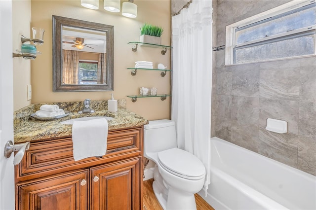 full bathroom featuring vanity, ceiling fan, shower / bathtub combination with curtain, hardwood / wood-style floors, and toilet