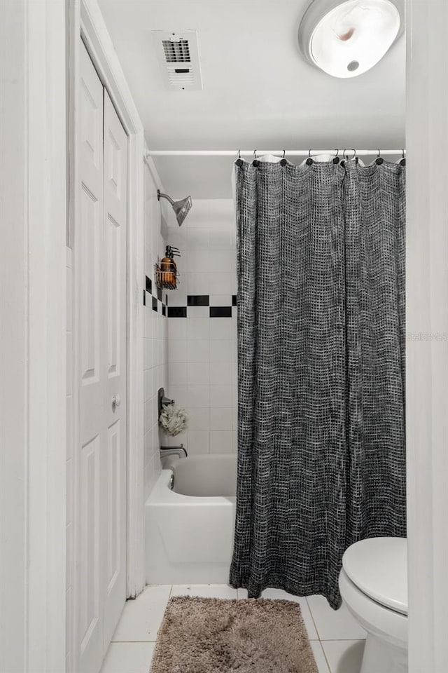 bathroom with tile patterned flooring, toilet, and shower / tub combo with curtain