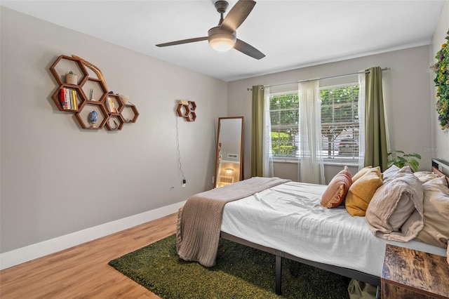 bedroom with ceiling fan and hardwood / wood-style floors