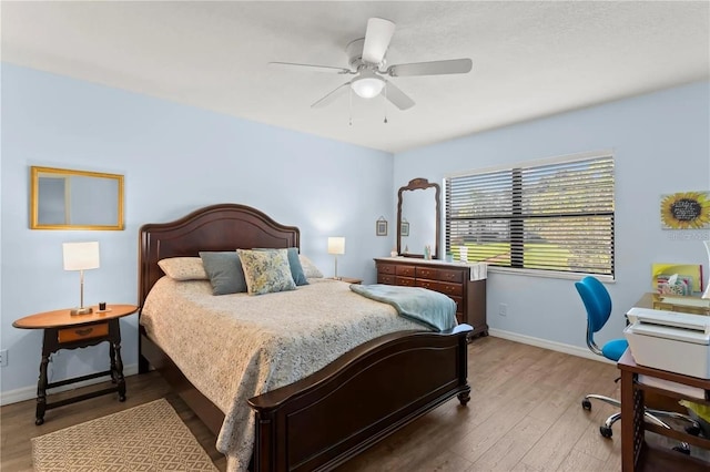 bedroom with ceiling fan and wood-type flooring