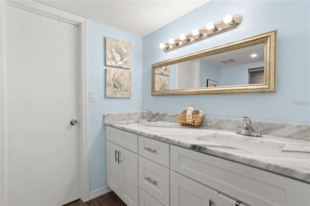 bathroom featuring vanity and wood-type flooring