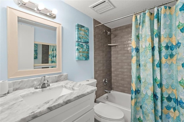 full bathroom featuring vanity, toilet, shower / bath combo with shower curtain, and a textured ceiling