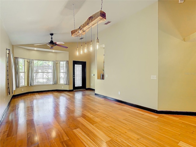 unfurnished room with wood-type flooring, ceiling fan, and lofted ceiling