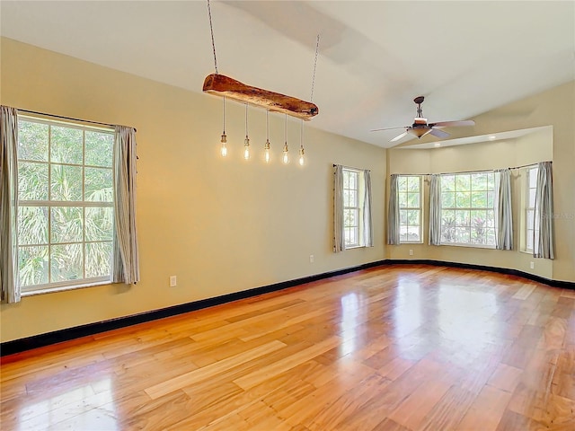 spare room with ceiling fan, a healthy amount of sunlight, and light wood-type flooring