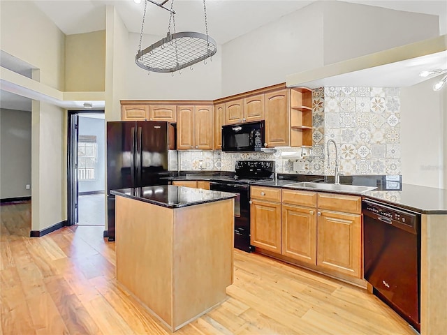 kitchen featuring backsplash, high vaulted ceiling, black appliances, sink, and light wood-type flooring