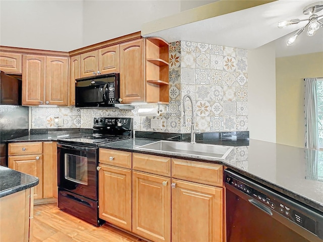 kitchen featuring decorative backsplash, sink, light hardwood / wood-style flooring, and black appliances