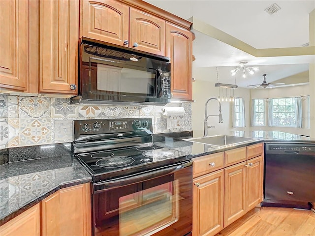 kitchen with black appliances, sink, ceiling fan, tasteful backsplash, and light hardwood / wood-style floors