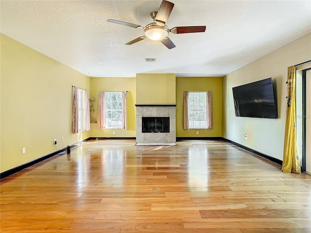 unfurnished living room with ceiling fan and light wood-type flooring