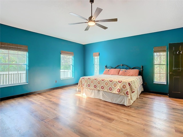 bedroom with ceiling fan and light wood-type flooring