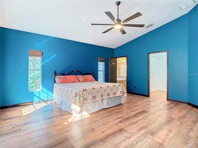 bedroom with ceiling fan, lofted ceiling, and light hardwood / wood-style flooring