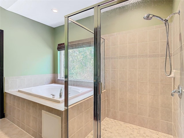 bathroom featuring tile patterned floors and independent shower and bath