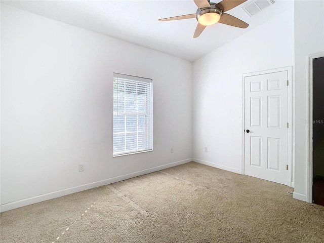 empty room featuring ceiling fan, carpet, and lofted ceiling