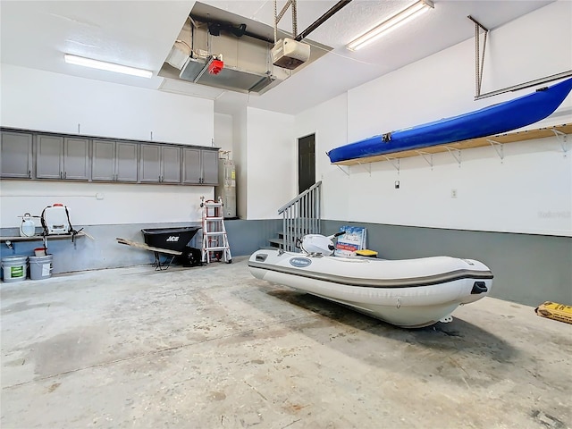 garage featuring a garage door opener and water heater