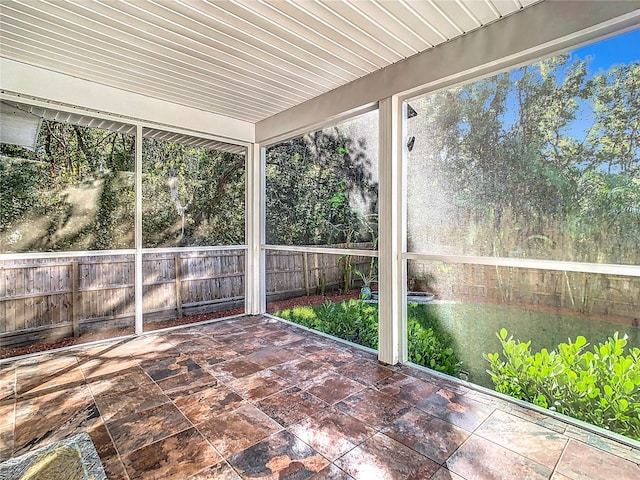 unfurnished sunroom with wood ceiling