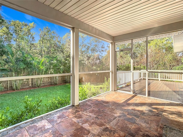 unfurnished sunroom featuring wood ceiling