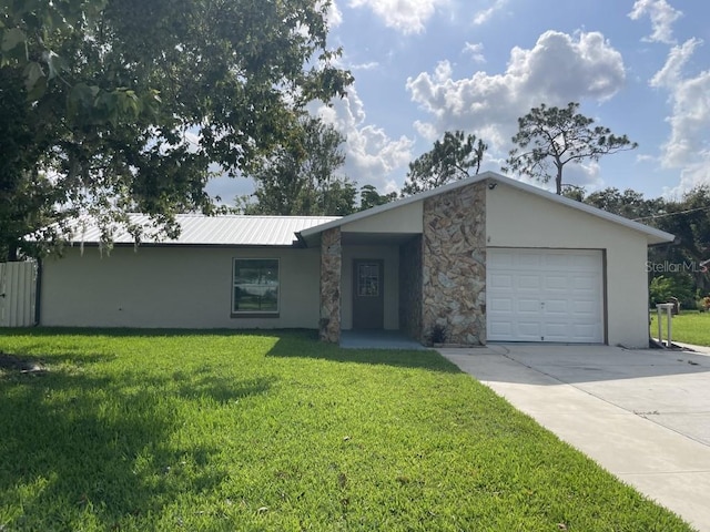 ranch-style home featuring a garage and a front lawn