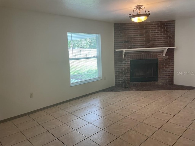 unfurnished living room featuring light tile patterned floors and a brick fireplace