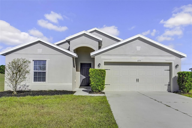 view of front of house with a front yard and a garage