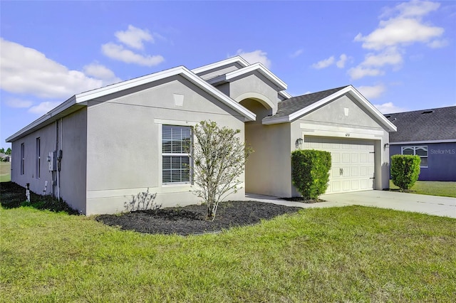 view of front of home with a garage and a front lawn