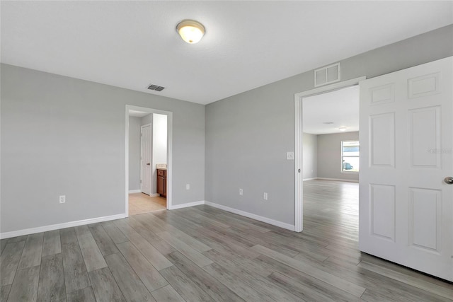 unfurnished room with light wood-type flooring