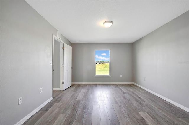 unfurnished room with light hardwood / wood-style floors