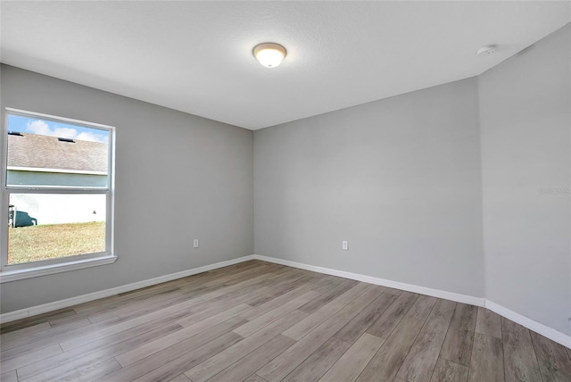 spare room featuring light wood-type flooring