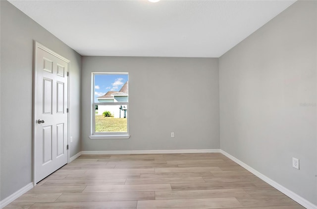 spare room featuring light wood-type flooring