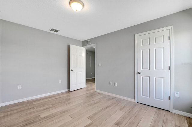 spare room with light hardwood / wood-style floors