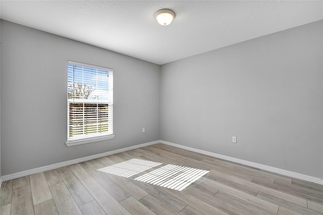 unfurnished room with light hardwood / wood-style floors