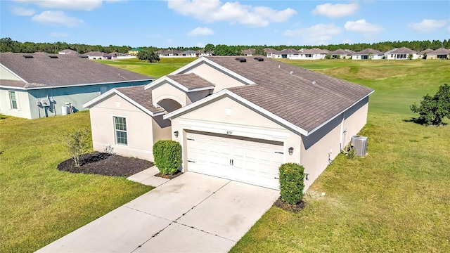 view of front of property featuring a front yard and a garage