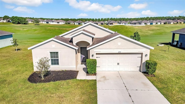 view of front of house featuring a front yard and a garage