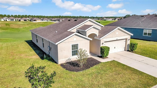 view of front of property with a garage and a front lawn