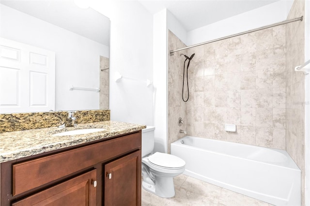 full bathroom featuring vanity, tile patterned flooring, tiled shower / bath, and toilet