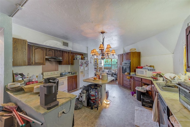 kitchen with pendant lighting, lofted ceiling, white appliances, a textured ceiling, and a chandelier