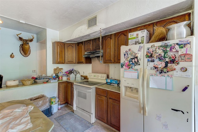 kitchen featuring a textured ceiling, white appliances, and backsplash